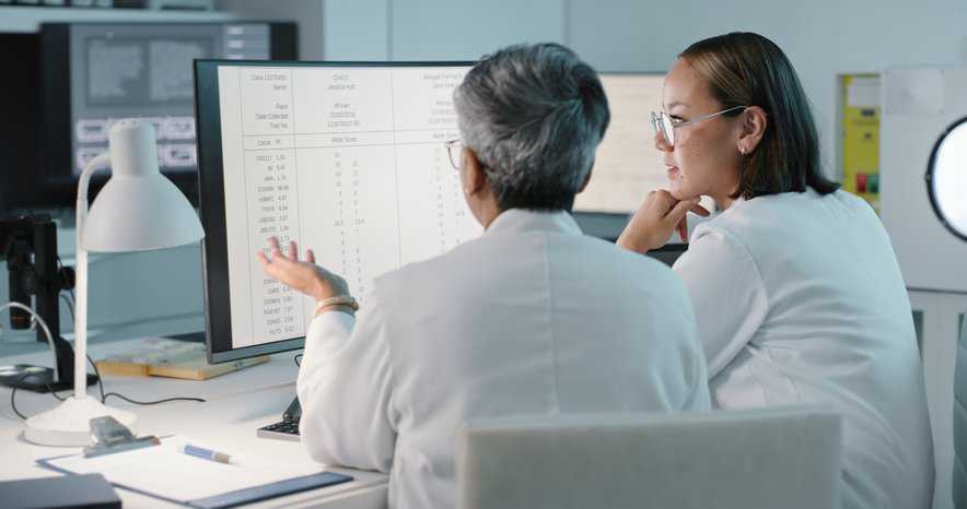 Doctors analyzing patient's data in a healthcare facility, adhering to ANSI/NEMA SC 1-2020.