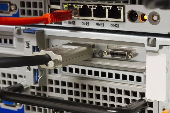 Close up of SCSI / SAS and ethernet network on rack servers in a workplace's datacenter. Small computer system interface adheres to INCITS 131-1994[S2013].