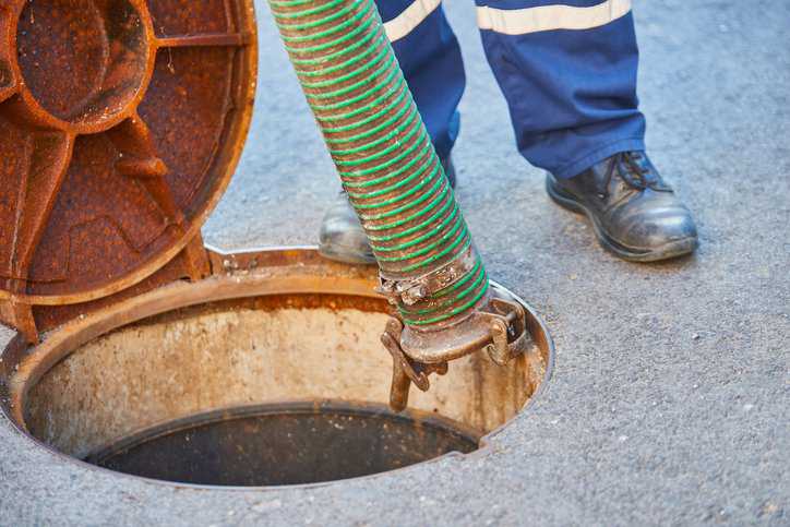 Emptying household septic tank/ residential wastewater treatment system that adheres to NSF/ANSI 40-2023.