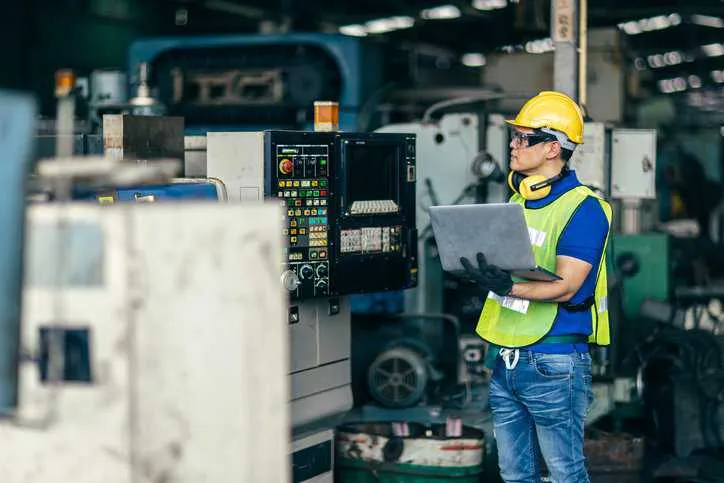 Machine operators reading graphic symbols on process equipment in a factor that adhere to ANSI/ISA S5.5-1985.