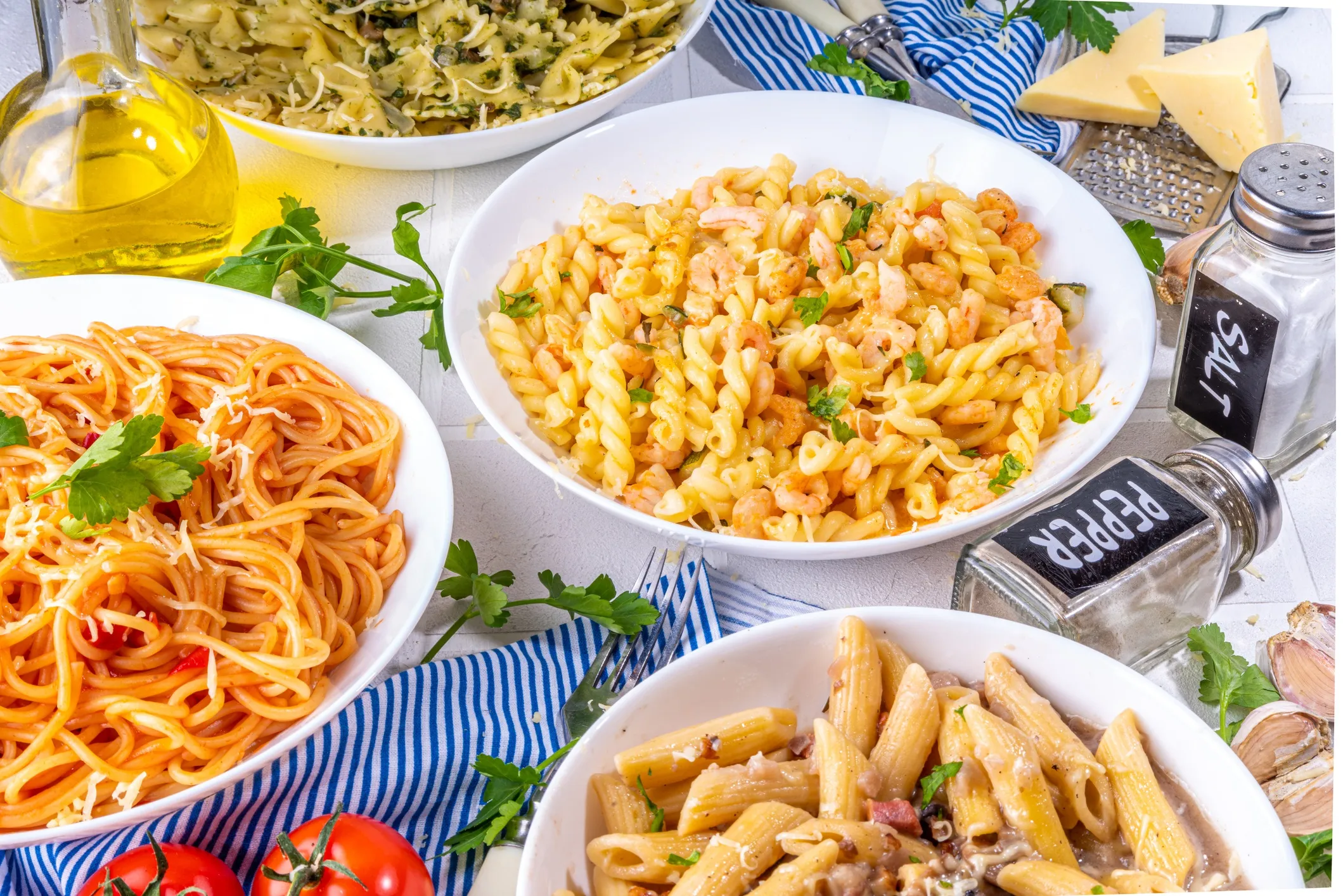 Variety of alimentary pasta on a dinner table that adheres to ISO 7304-1:2016 cooking quality specifications.