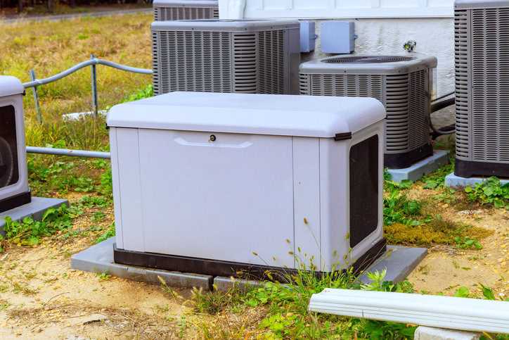White home generator near multiple AC units.