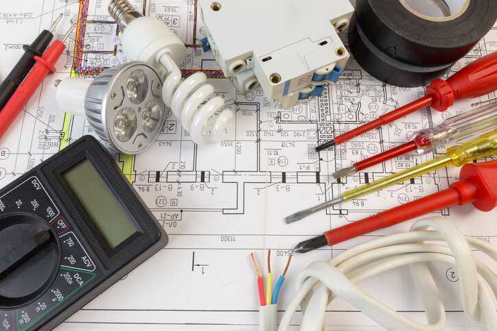 Electrical construction symbols and drawing, adhering to NECA 100-2024, that depict electrical wiring, equipment, and circuitry of a building.