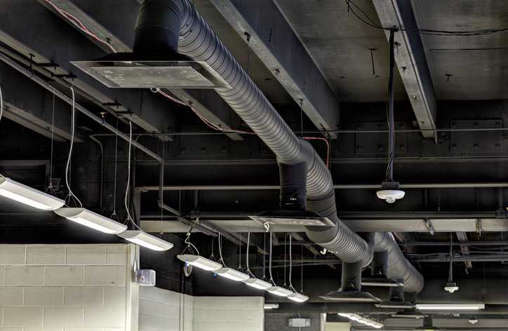 Duct work in a modern commercial HVAC system that adheres to Fire, Smoke, and Radiation Damper Installation Guide for HVAC Systems, 6th Edition.