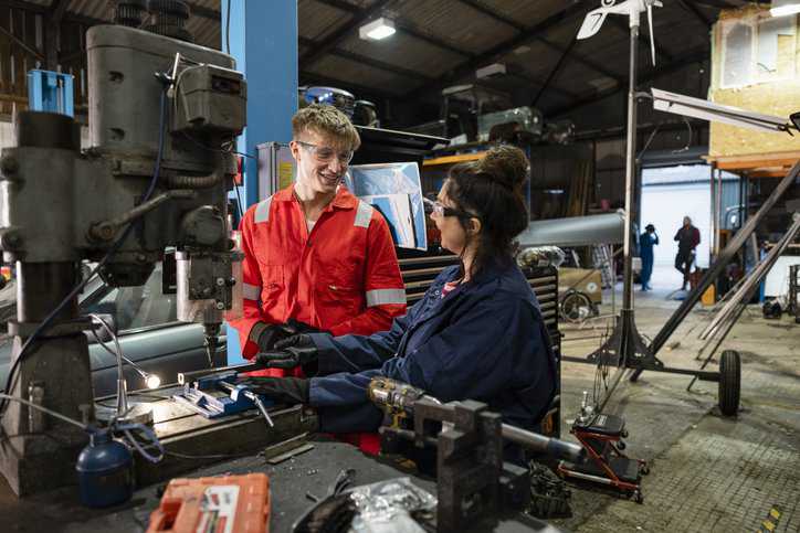 Mechanics working on improving sustainability by remanufacturing metal products, adhering to ANSI RICOO1.2-2021 guidelines.