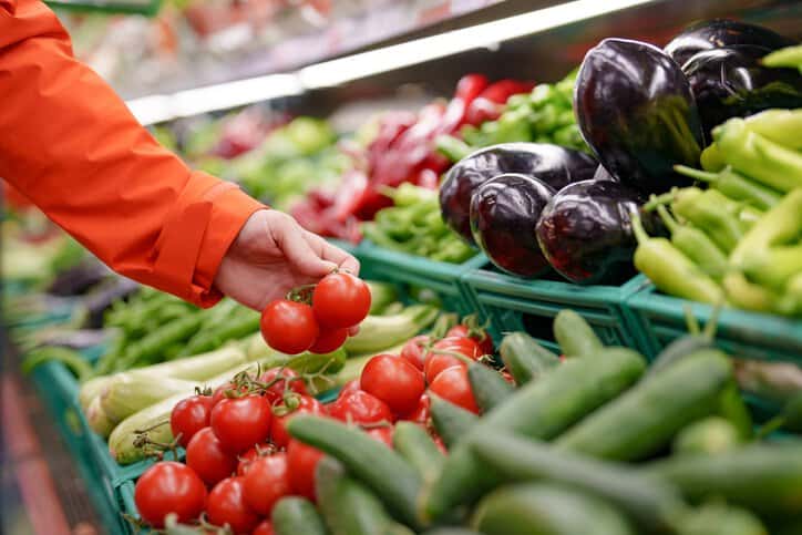Consumer shopping in a healthy, organic grocery market for food that is safe to consumer, thereby passing various food safety standards.