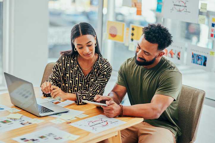 Two marketing professionals gathering marketing data, while adhering to ISO 9001, ISO 20252, ISO 19731, and ISO20671 international standards for business and marketing.