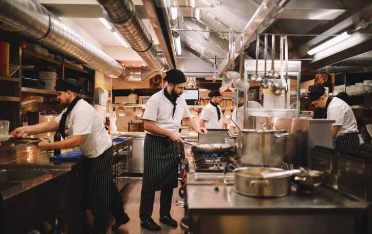 Restaurant crew in kitchen.