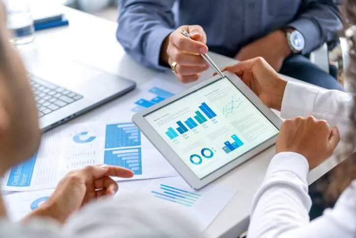 Businessmen examining the compliance management of their company with the help of ANSI Compliance Connect.