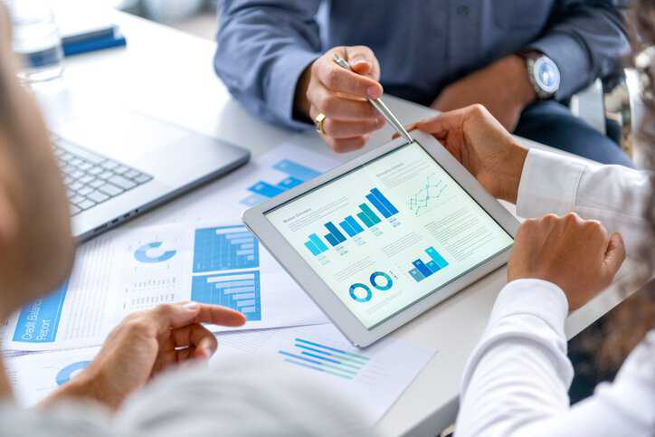 Businessmen examining the compliance management of their company with the help of ANSI Compliance Connect.