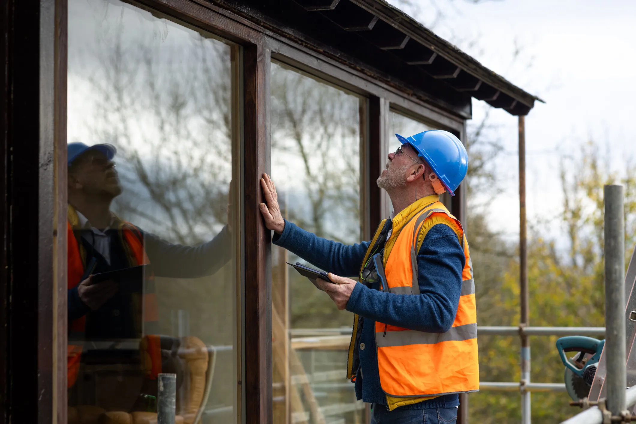 Workers building the frame of a residential home that complies with the 2024 International Residential Code (ICC-IRC 2024).