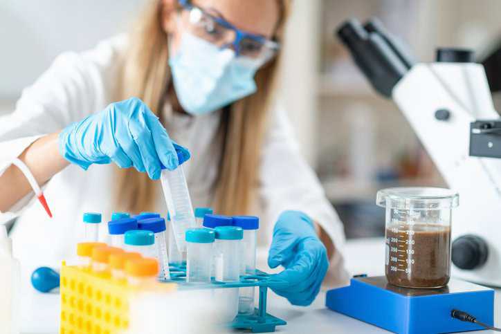 Researcher in a laboratory conducting gut microbiome research that adheres to ISO standards.