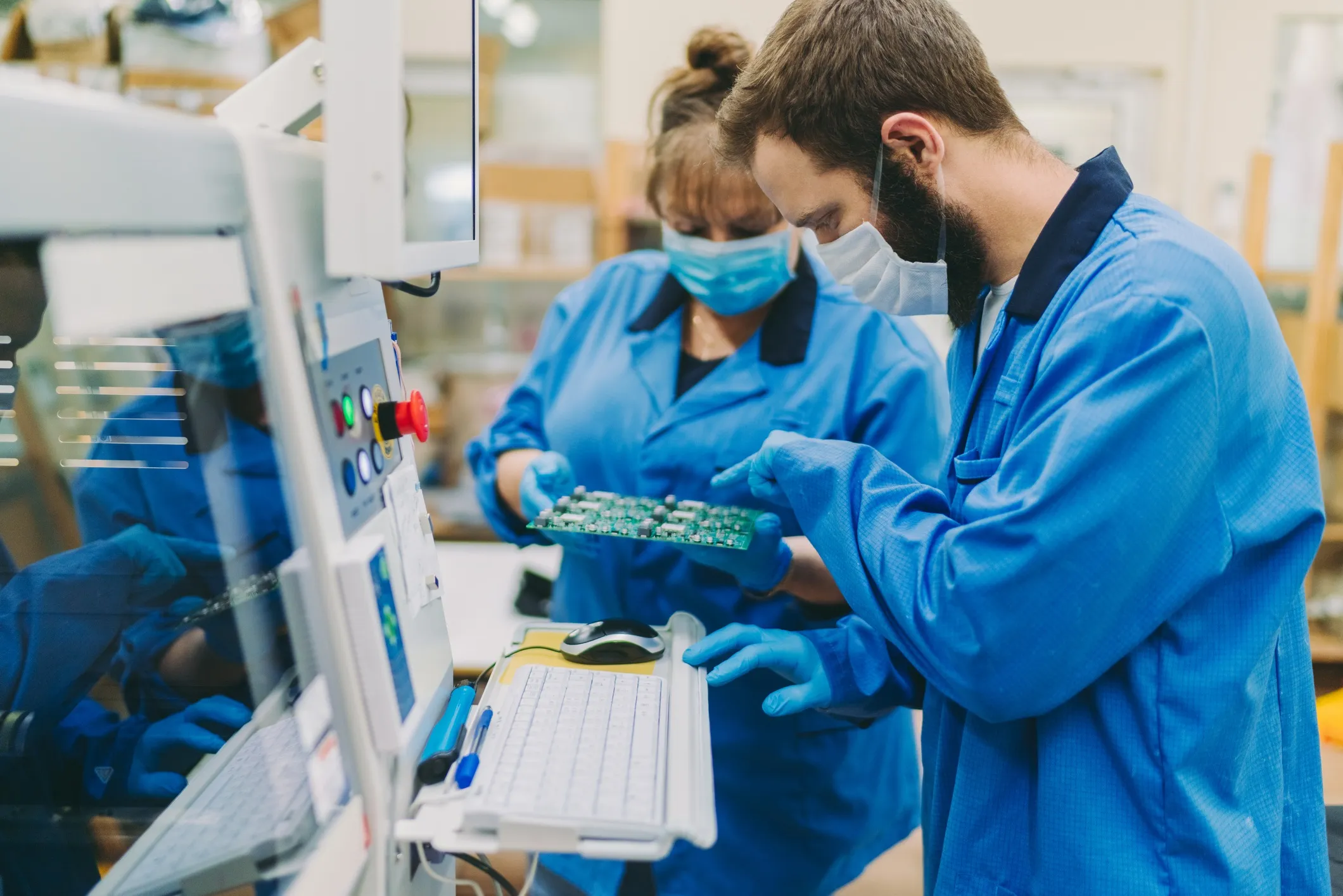 Quality control team working in electronics production factory, assuring electronics adhere to IPC-1792  cybersecurity guidelines.
