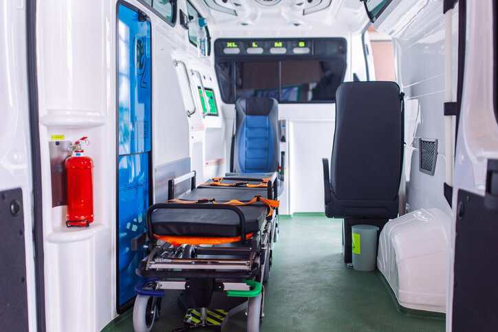 Interior of modern equipped ambulance vehicle equipped with medical devices to ship to an external health care facility, while adhering to AAMI TIR109:2025.