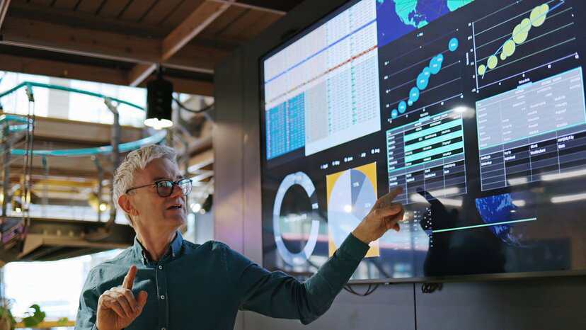 Businessman holding a work meeting to discuss new risk management approaches AI in business that adhere to ISO/IEC 42001, ISO/IEC 23053, and ISO/IEC 23894.