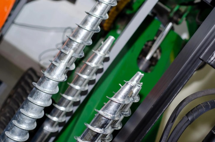 Close up of metallic drive screw used for manufacturing that adheres to ASME B18.6.3-2024.