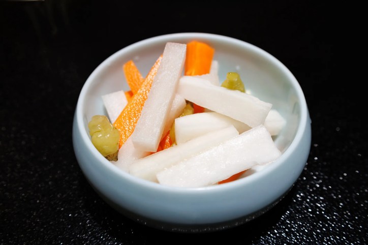 Pao cai (pickled vegetables) in a bowl that adhere to ISO 24220:2020.
