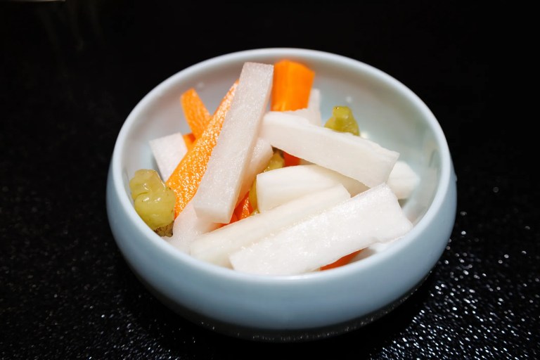 Pao cai (pickled vegetables) in a bowl that adhere to ISO 24220:2020.