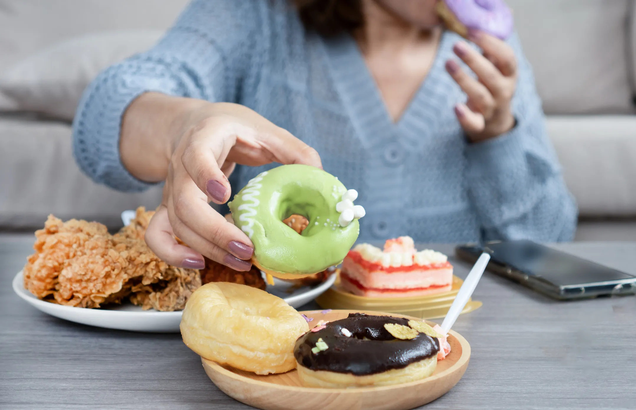 A woman eating unhealthy junk food.