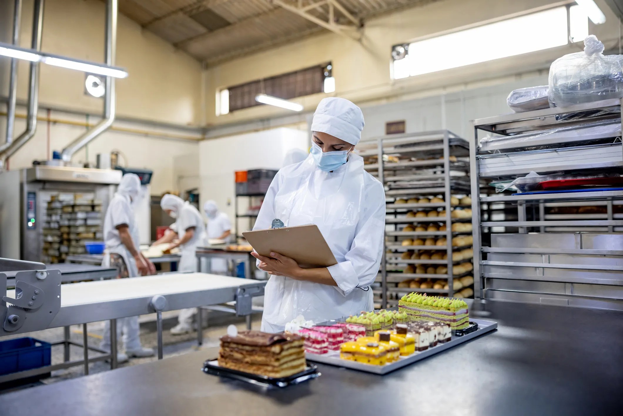 Quality management audit being conducted at an industrial bakery that adheres to ISO 22002-1:2025.
