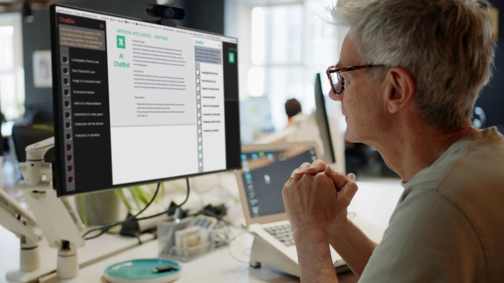 Woman interacting with an AI chatbot interface on a laptop, exploring AI-driven tools for enhancing critical thinking and learning.