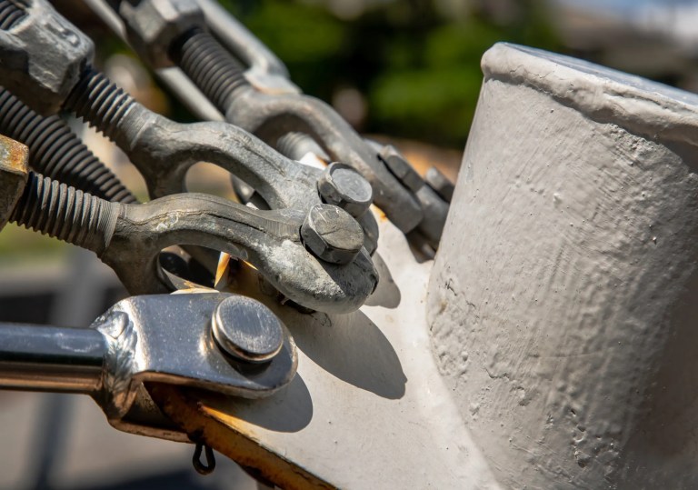 Various types of rigging hardware as defined by ASME B30.26, including shackles, eyebolts, and turnbuckles.