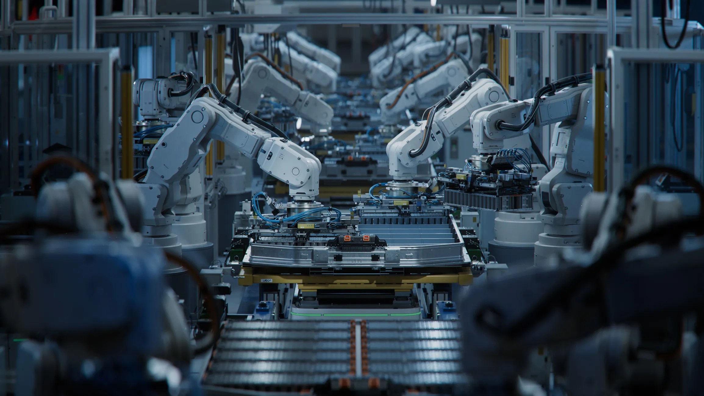 . A row of robotic arms—sleek, multi-jointed machines—dance in synchronized motion along an assembly line while adhering to ANSI/A3 R15.06-2025.