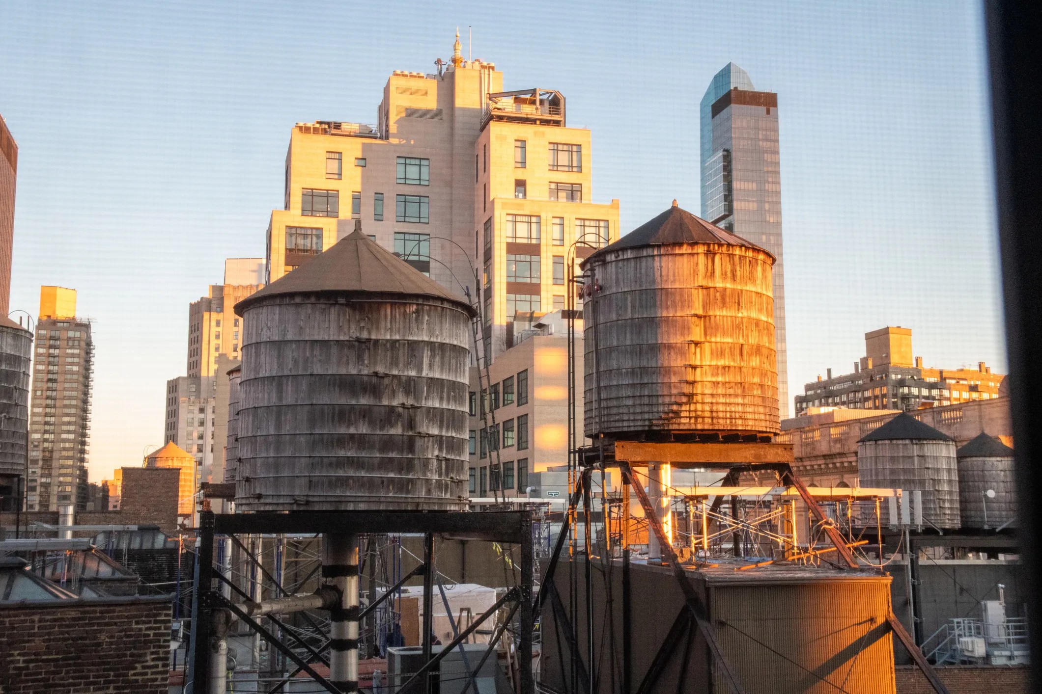 Historic wooden water towers atop New York City buildings, showcasing the city's unique water distribution system and urban skyline.