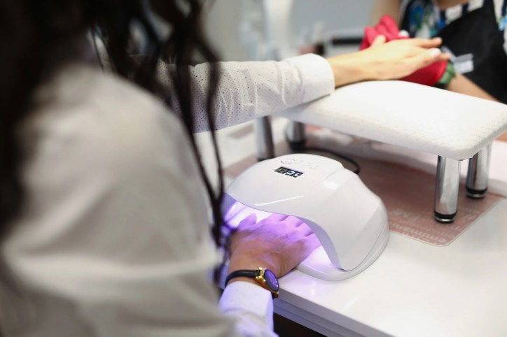 Woman getting gel manicure with TPO-based formula in a nail salon in the U.S.