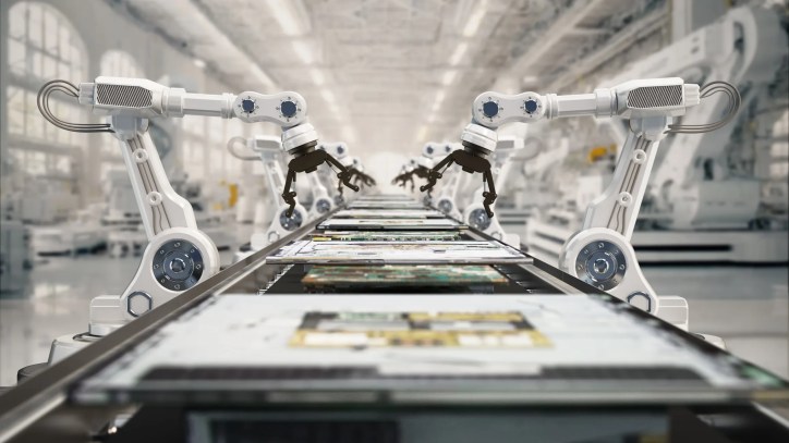 Automated robotic arms powered by AI assembling components on a factory production line. The environment is clean and modern, with machines operating efficiently and minimal human presence.