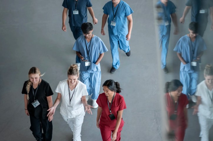 Group of behavioral assistants walking in scrubs