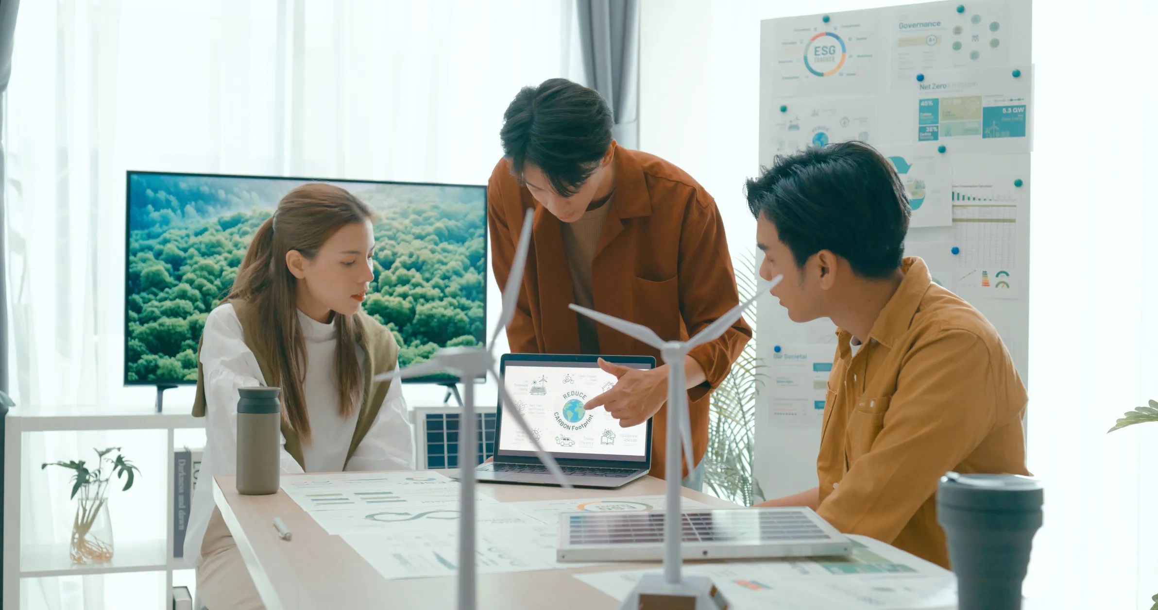 Team of professionals implementing green coding practices to enhance sustainability, aligned with ISO 14001 environmental management principles.