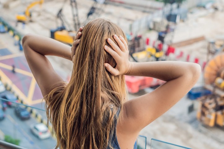 Illustration of sound waves traveling through the atmosphere, showing how sound absorption occurs due to environmental factors like temperature, humidity, and pressure. The image represents the principles of sound attenuation as described in ASA/ANSI ASA S1.26-2014 (R2024).