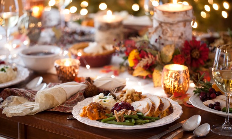 Beautiful Thanksgiving dinner table setting featuring impact-resistant plates, flame-resistant linens, and UL-certified holiday lights, highlighting how ASTM and UL standards assure safety and durability.
