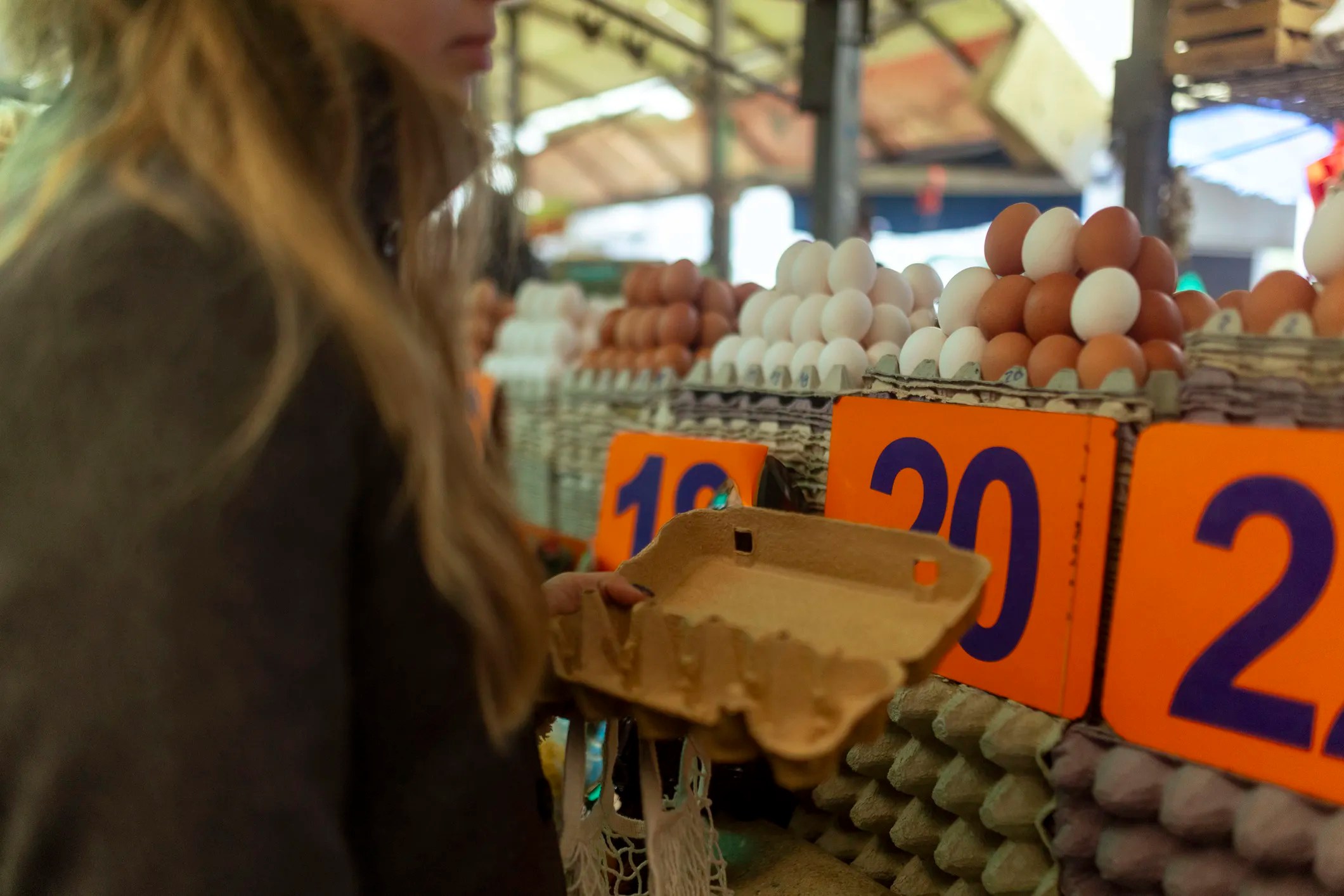 Fresh eggs sold unrefrigerated in a European grocery store, showcasing common European egg storage practices that prioritize natural protection against Salmonella without refrigeration.