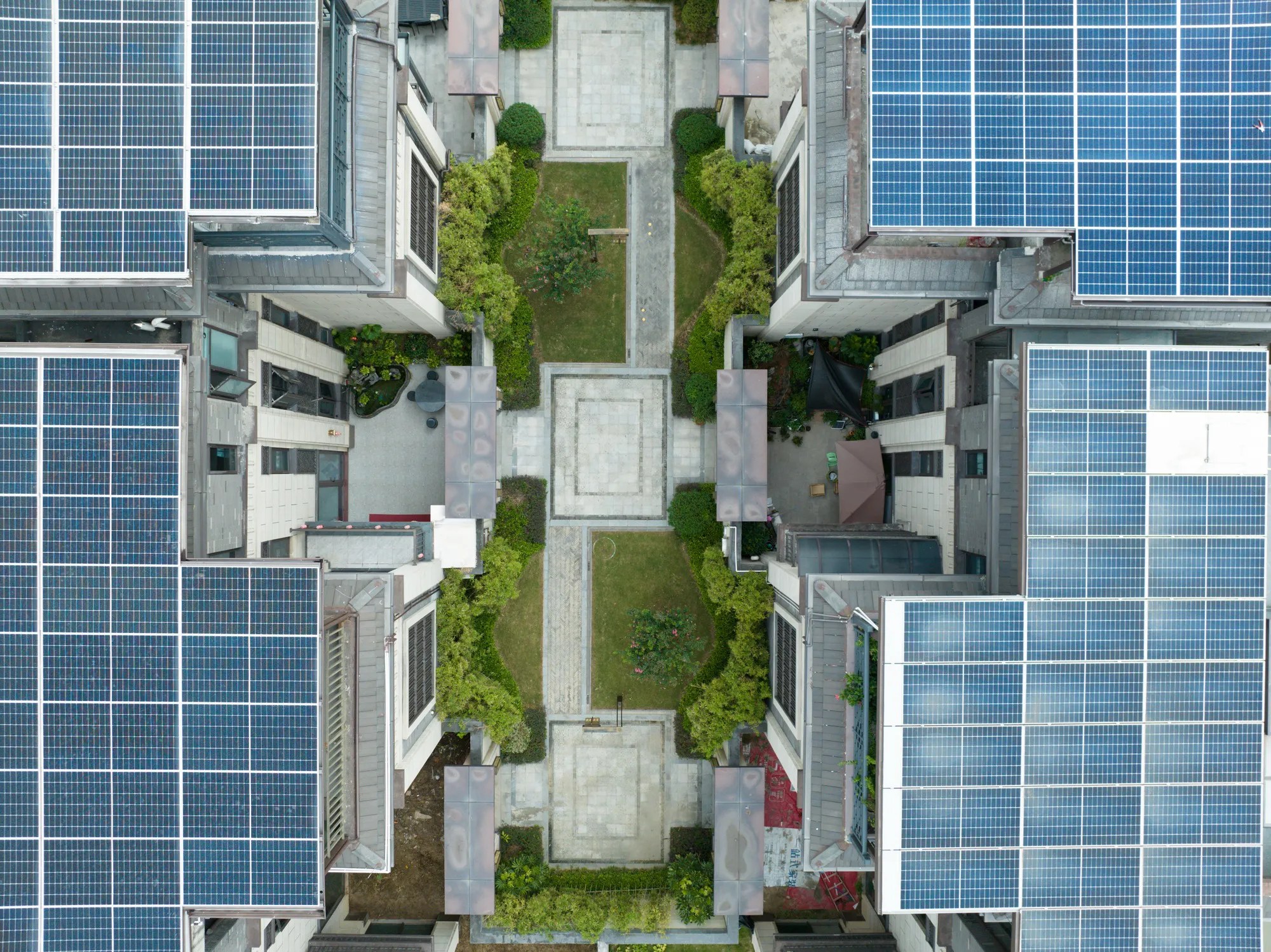 Modern energy-efficient building with ISO 50001:2018 smart design features like solar panels, LED lighting, and high-performance insulation, reducing energy consumption and minimizing environmental impact.