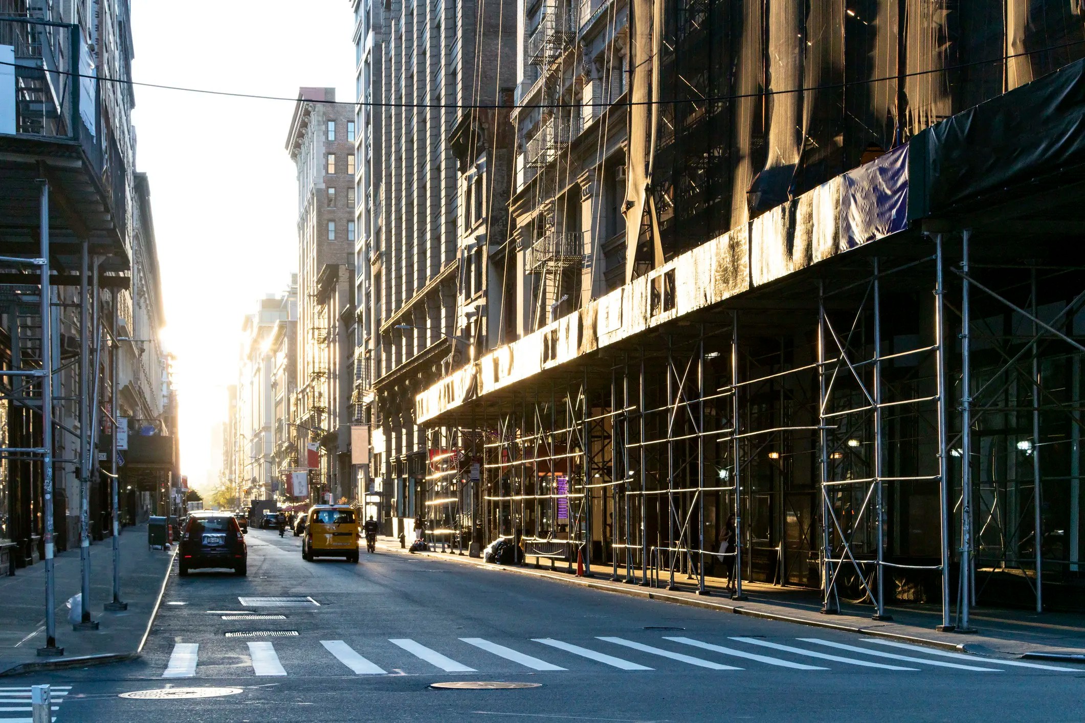 Scaffolding and sidewalk shed surrounding a New York City building during façade safety inspections.