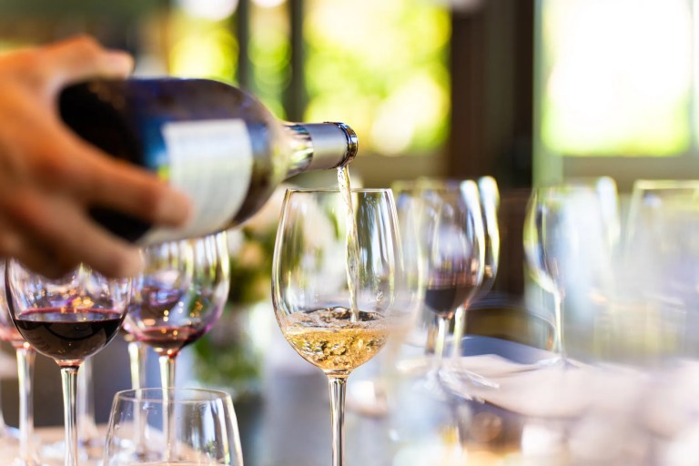 Standard ISO 3591:1977 wine-tasting glass with narrow rim and wide bowl for optimal aroma, flavor, and color evaluation.