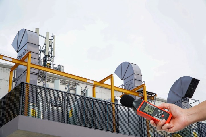 Measuring sound power levels from industrial machinery in an acoustic testing environment that complies with ISO 3744:2025.