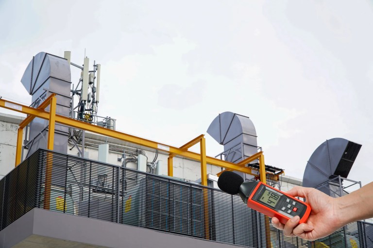 Measuring sound power levels from industrial machinery in an acoustic testing environment that complies with ISO 3744:2025.