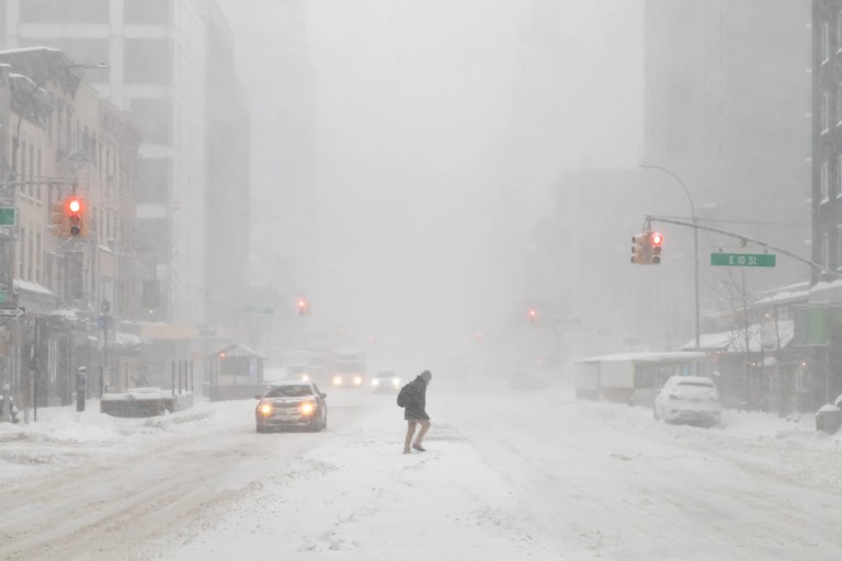Winter storm in New York City with heavy snow and icy conditions affecting roads and infrastructure during a cold season, but luckily the roads and infrastructure adhere to ASTM B117-26 guidelines for salt spray (fog) testing.
