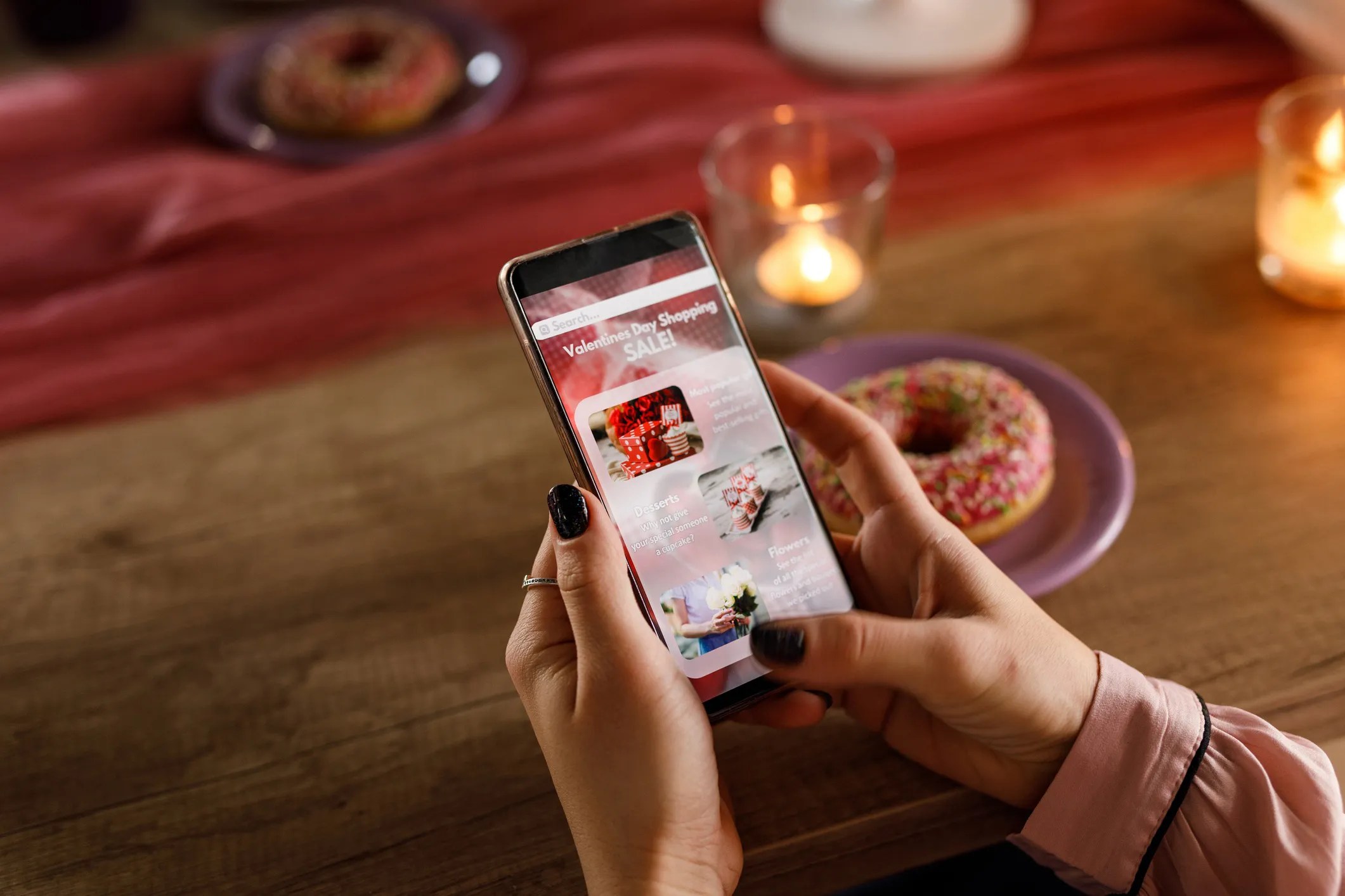 iPhone displaying a Valentine’s Day gifting advertisement with chocolates, flowers, and heart-themed graphics.