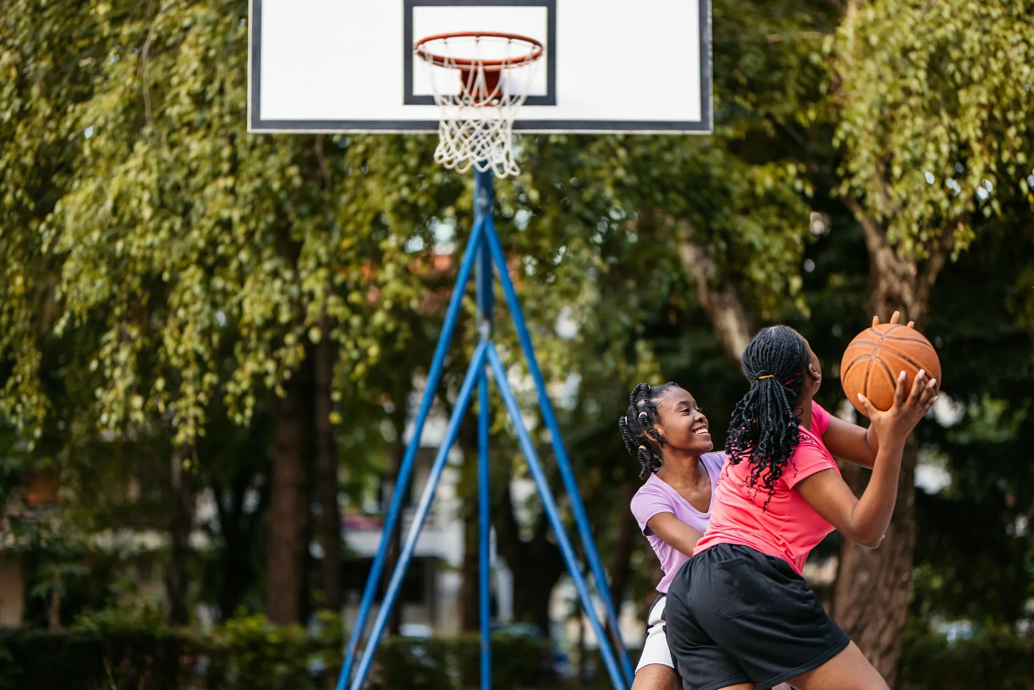 Basketball court and equipment meeting ASTM safety standards, ensuring safe play for players in both public and residential settings.