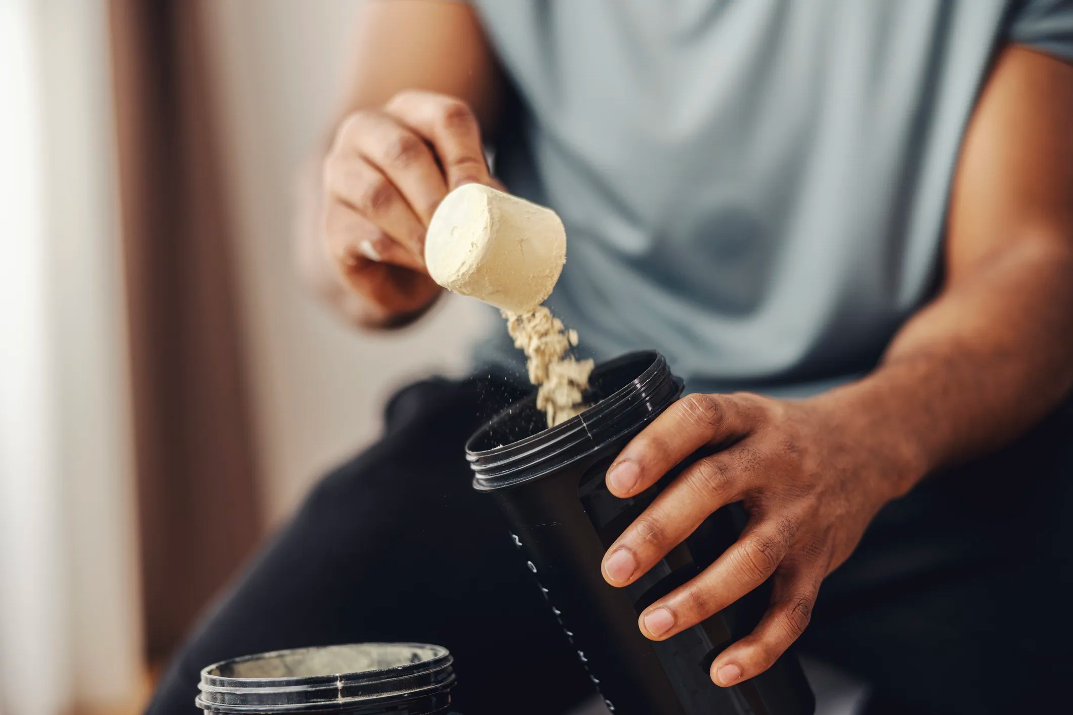 Professional body building taking creatine dietary supplement to help with his health, nutrition, and muscle growth.