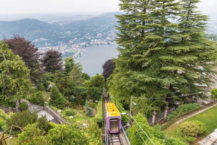 Funicular railway, adhering to ANSI B77.2-2025, ascending a steep hillside with passengers, showcasing safe and efficient cable-based transportation engineering.