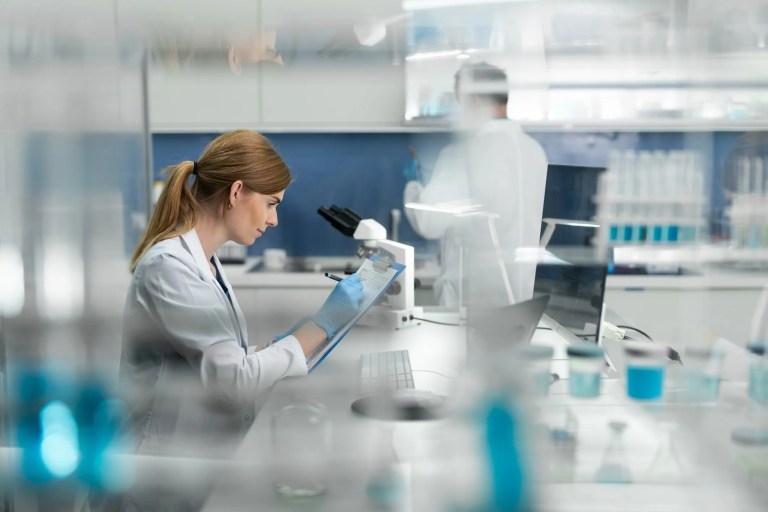 Researchers monitoring a medical device clinical trial with patient safety and data integrity aligned to ISO 14155:2026 guidelines.