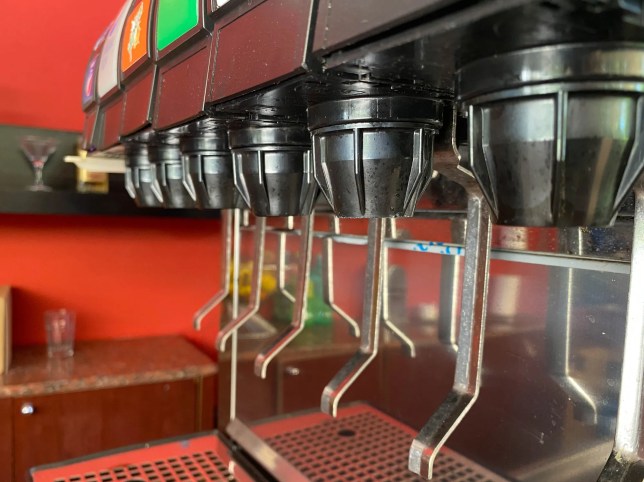 Self-service beverage and condiment dispensers in a commercial foodservice setting compliant with the NSF/ANSI 18-2025 sanitation standard.