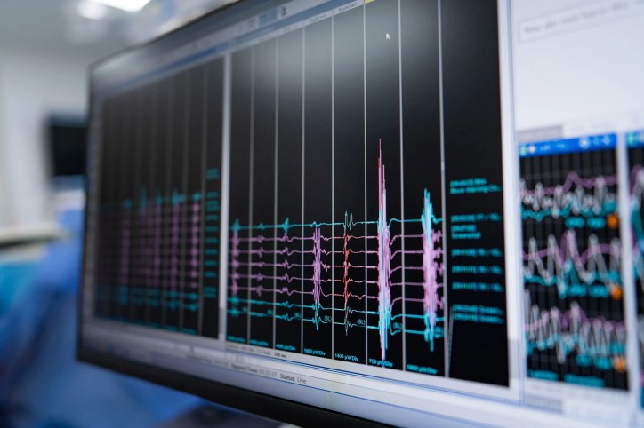 Engineers using acoustic measurement equipment to analyze sound pressure and vibration levels under standardized reference values as detailed in ASA/ANSI S1.8-2016 (R2025).
