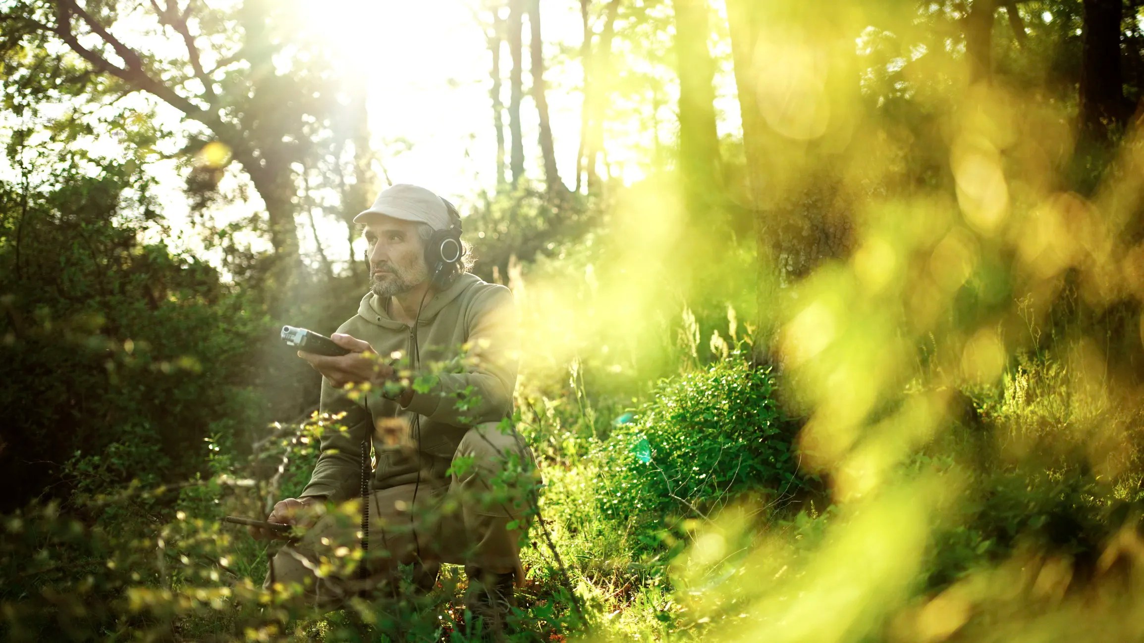 Researcher collecting bioacoustic recordings in the wild to study animal communication using AI and wildlife sound analysis.