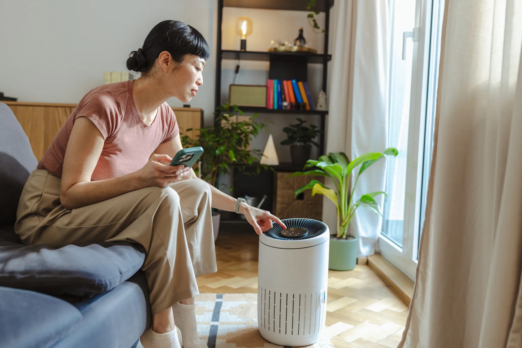 Portable household air cleaner operating in a home environment to improve indoor air quality by removing airborne particles.